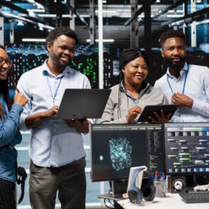 Cheerful data center experts working together, using deep learning algorithms and node trees to analyze datasets. Jolly server farm teamworking colleagues using AI to recognize facility data patterns